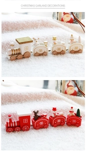 Detail of red and white wooden Christmas train with miniature snowmen and gift figurines