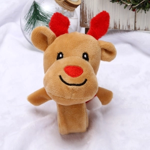 Gros plan d'un bracelet de Noël en peluche renne avec bois rouges sur fond de neige douce