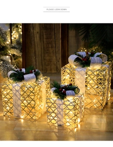 Three-piece set of lit Christmas gift boxes with gold metal mesh and pine cone accents