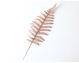 Detail of rose gold glittery artificial fern leaf for Christmas tree decoration