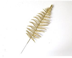 Macro shot of artificial golden glitter fern leaf for Christmas tree decoration
