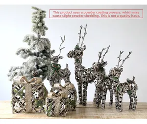 Detailed view of woven rattan reindeer and star gift boxes with festive golden glitter