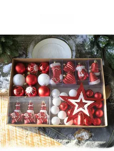 Flat lay of a red and white Christmas ornament set with tree topper on a wooden table