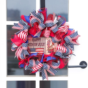 Patriotic Independence Day wreath with red blue white ribbons and Happy 4th of July sign