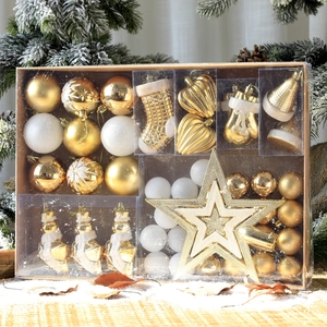 Gold and white Christmas ornaments set with star tree topper in snow-themed display