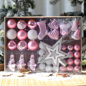 Pink and white Christmas ornament set with tree topper in a kraft gift box