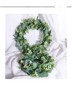 Close-up of dual Nordic eucalyptus wreaths with lush green leaves and small white flowers