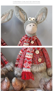 Detail of grey plush Christmas donkey doll showing knit sweater and wood buttons