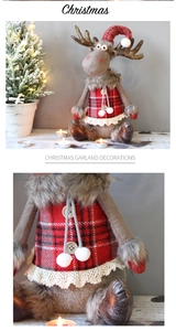 Close-up of reindeer plush ornament showing red plaid skirt and soft fur detail