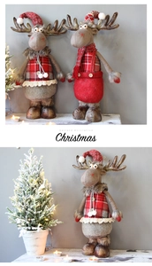 Detail of reindeer plush figures in red plaid outfits for Christmas decoration