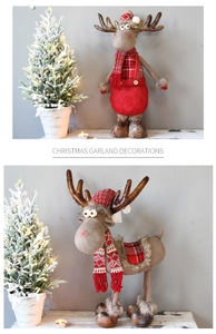 Close-up of reindeer plush ornaments with red plaid scarves and knit hats for Christmas