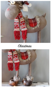 Close-up of a Christmas reindeer plush with knitted scarf and plaid saddle detail