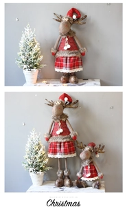 Detailed view of plush reindeer dolls with red plaid scarves and hats for Christmas decor