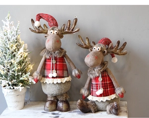 Detail of plush reindeer Christmas ornaments featuring red plaid sweaters and knit hats