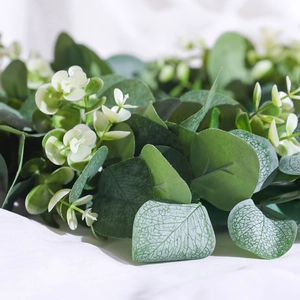 Nordic artificial eucalyptus and baby's breath wreath with green leaves on white fabric