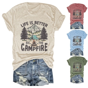 Detail view of campfire t-shirts in cream, red, blue, and green with outdoor prints