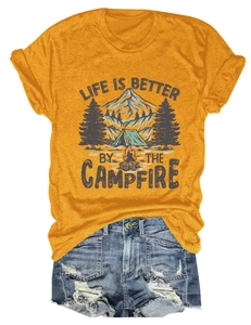Detail of campfire print on mustard yellow t-shirt with distressed denim shorts