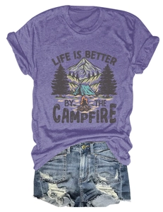 Detailed close-up of a purple cotton t-shirt with campfire illustration and graphic text