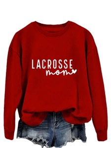 Detail of red lacrosse mom sweatshirt with heart print and distressed denim shorts
