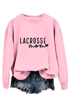 Close-up of pink lacrosse mom sweatshirt with black lettering and heart icon