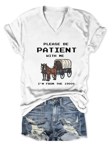 Flat lay of a white V-neck T-shirt with vintage carriage print and distressed denim shorts