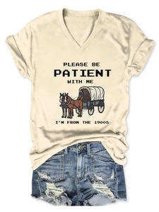 Detail of vintage beige V-neck t-shirt with slogan and distressed blue denim shorts