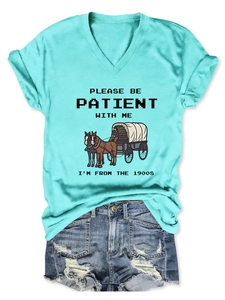 Detail of teal V-neck tee with 1900s slogan print and distressed denim shorts