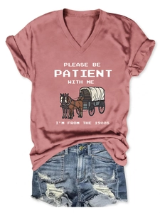 Flat lay of pink V-neck T-shirt with vintage slogan and distressed denim shorts set