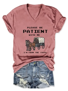 Detail of dusty pink V-neck T-shirt with vintage horse carriage print and denim shorts