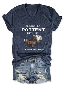 Close-up of navy blue V-neck T-shirt with pixel art graphic and white text printing