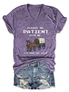 Detail of V-neck purple heather T-shirt with pixel art and distressed denim shorts
