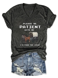 Close-up of vintage print on charcoal V-neck tee with distressed denim shorts