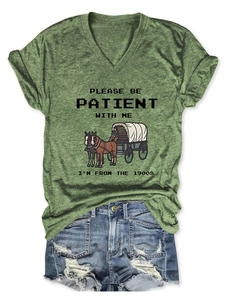 Close-up of vintage slogan print on a casual V-neck T-shirt paired with denim shorts