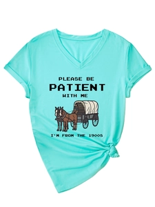 Close-up of mint green V-neck T-shirt with vintage 1900s slogan and knotted hem detail