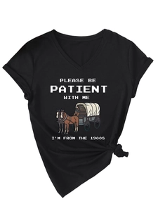 Detail of V-neck black T-shirt featuring Please Be Patient print and stylish hem knot