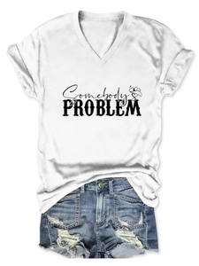 Close-up of Somebody's Problem print on a white V-neck T-shirt with distressed denim shorts