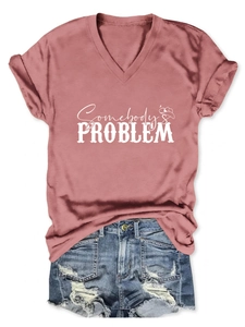 Flat lay of v-neck t-shirt with Somebody's Problem print and denim shorts