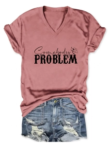 Flat lay of pink V-neck T-shirt with Somebody's Problem print and distressed denim shorts