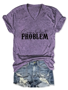 Flat lay of purple V-neck t-shirt with Somebody's Problem print and denim shorts