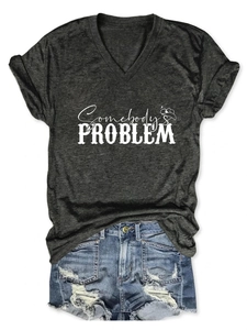 Detail of V-neck dark grey T-shirt with Somebody's Problem print and ripped denim shorts