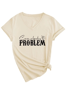 Detail of V-neck apricot T-shirt with Somebody's Problem print and stylish hem knot