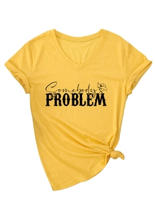 Detail of yellow V-neck T-shirt with Somebody's Problem print and stylish front knot