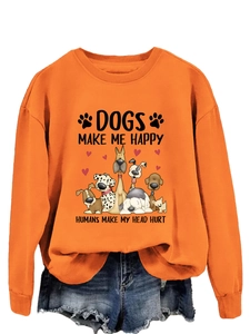 Détail du sweat-shirt orange vif avec imprimé de chiens de dessin animé amusant