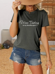 Detail of grey T-shirt with white Wine Tasting is my favorite sport text and denim shorts