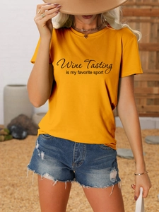 Close-up of mustard yellow t-shirt with Wine Tasting is my favorite sport print
