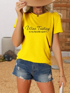 Close-up of yellow cotton T-shirt with black Wine Tasting Is My Favorite Sport print