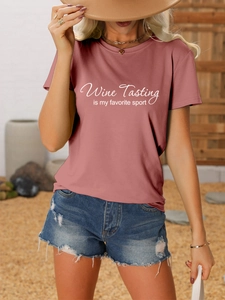 Detail of wine tasting quote print on dusty rose t-shirt paired with denim shorts