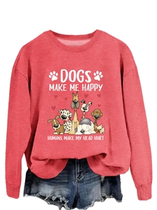 Détail du sweat rose corail avec imprimé chiens de dessin animé et texte humoristique