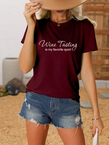 Detail of burgundy T-shirt with Wine Tasting text print styled with denim shorts