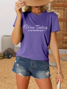 Detail shot of purple t-shirt with wine tasting print and frayed blue denim shorts